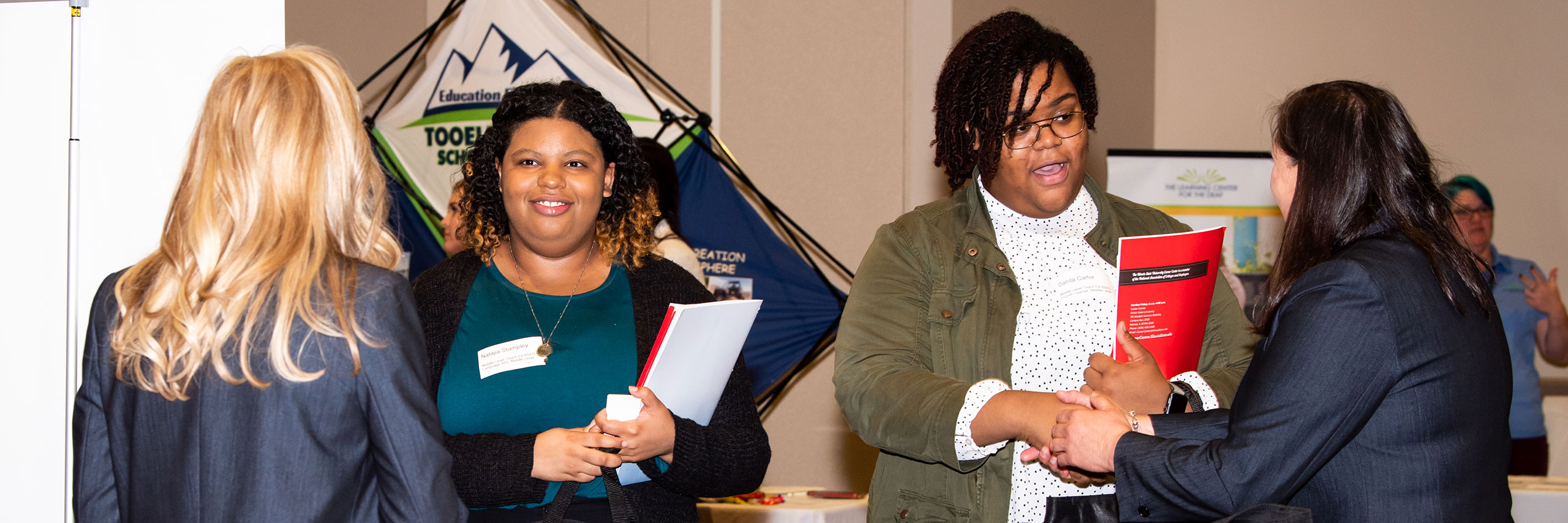 Women discussing at an event.